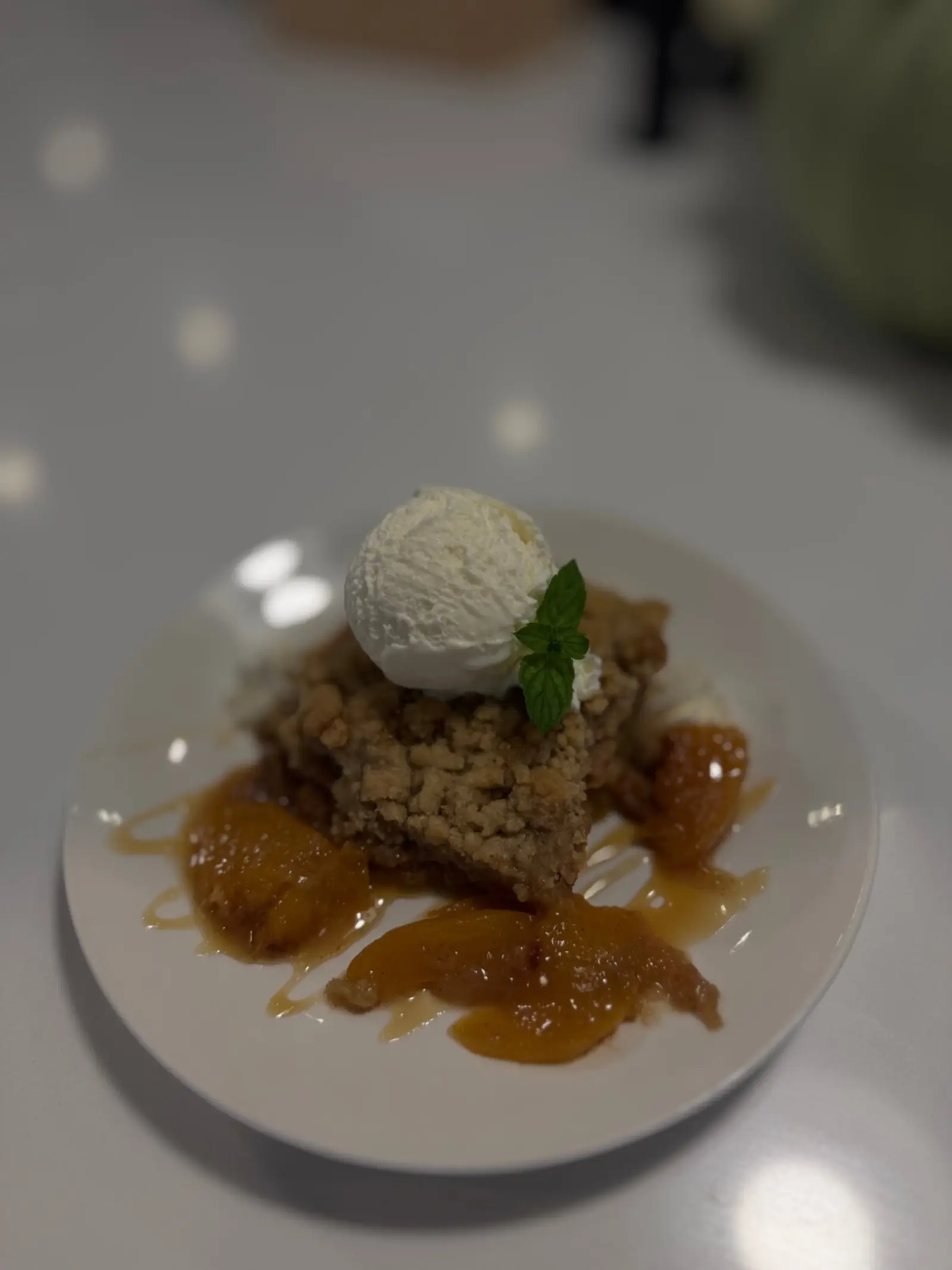 Fruit crumble with ice cream and mint
